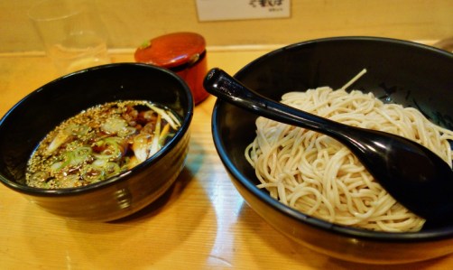 Dipping soba noodles into hot broth (Tokyo, Japan)